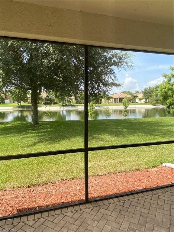 unfurnished sunroom featuring a water view