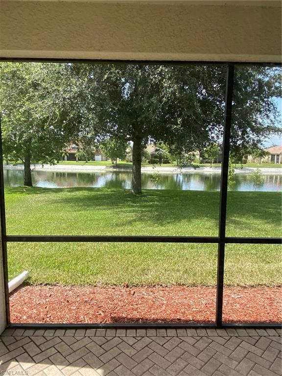 unfurnished sunroom with a water view