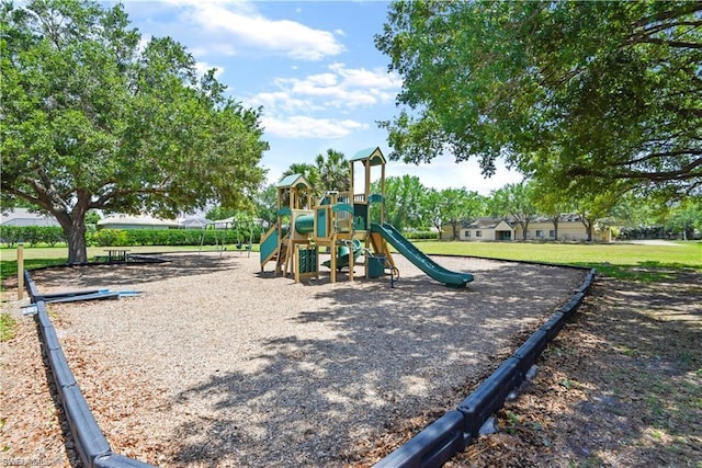 view of jungle gym featuring a lawn