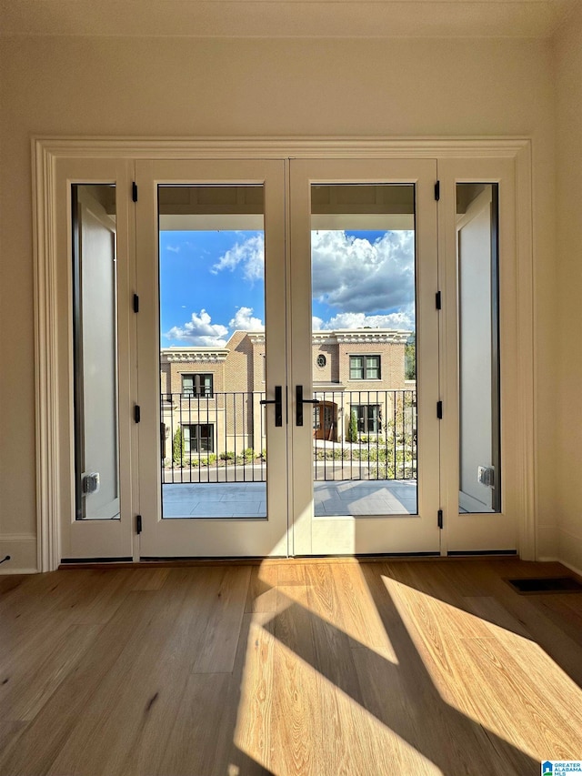 doorway featuring french doors and light hardwood / wood-style floors