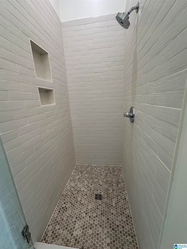 bathroom with a tile shower