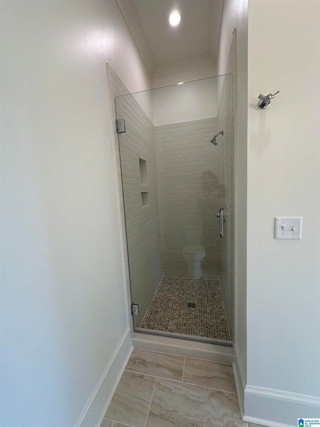 bathroom featuring walk in shower and toilet