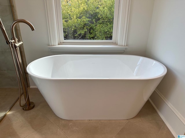 bathroom featuring a tub to relax in and tile patterned floors