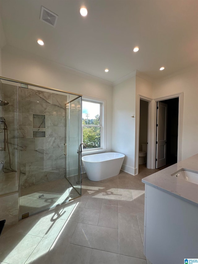 full bathroom featuring vanity, tile patterned flooring, separate shower and tub, and toilet