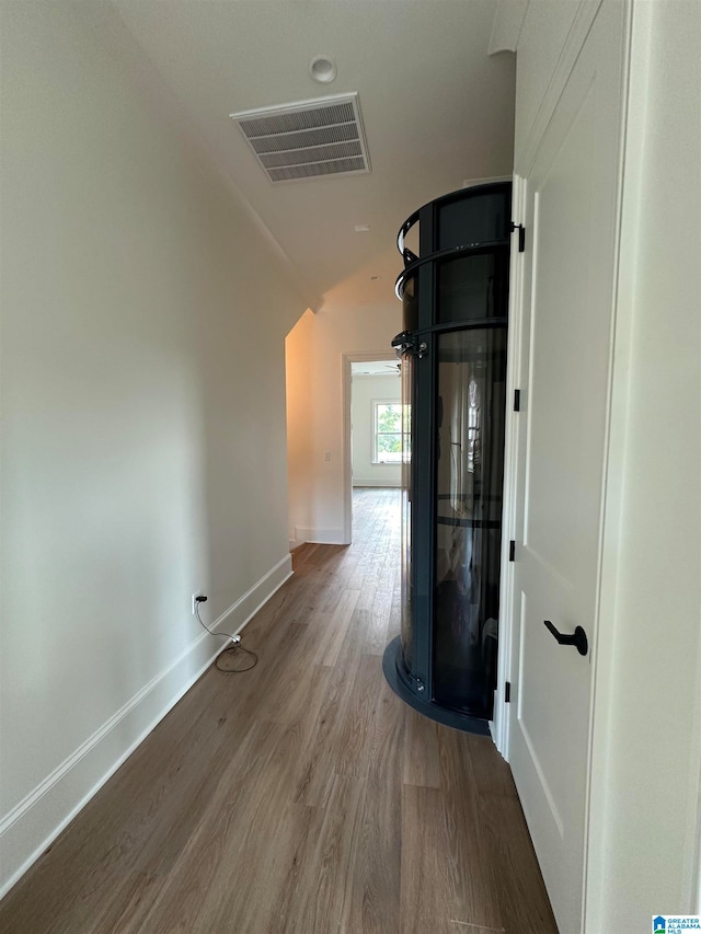 hallway with hardwood / wood-style floors