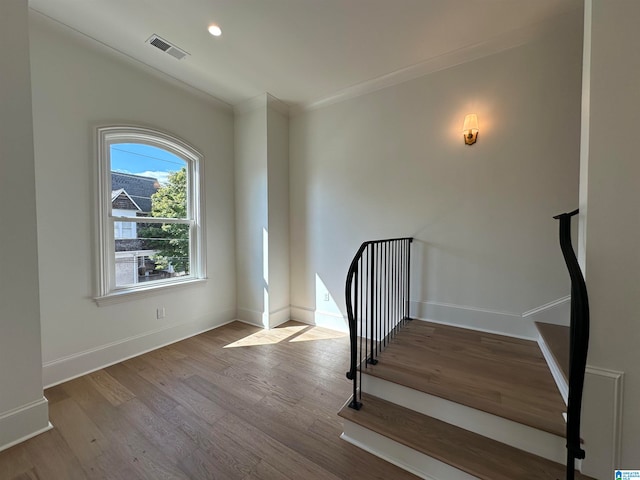 interior space featuring crown molding and hardwood / wood-style floors