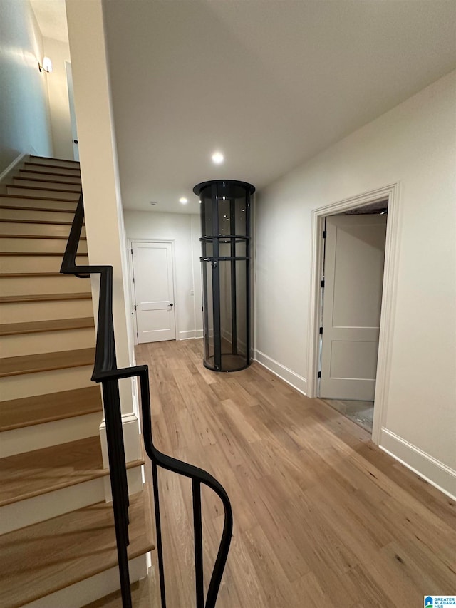 stairs featuring hardwood / wood-style flooring