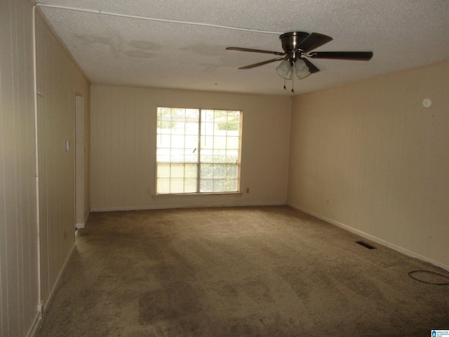 carpeted empty room featuring a textured ceiling and ceiling fan