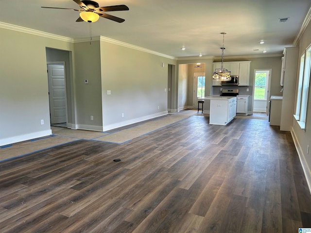 kitchen featuring pendant lighting, a center island, white cabinets, dark hardwood / wood-style floors, and ornamental molding