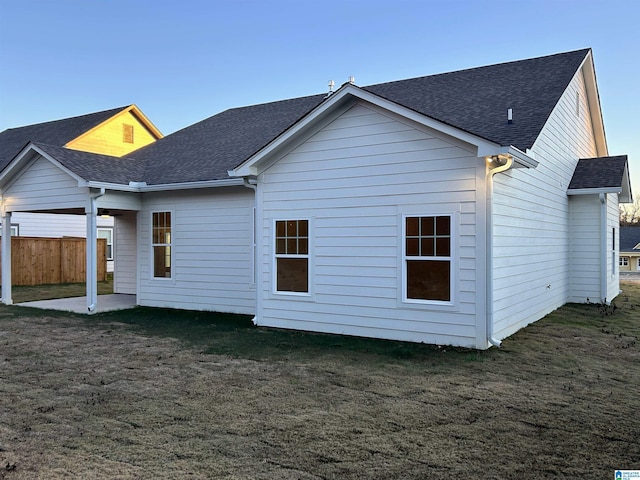 back of house featuring a patio and a lawn