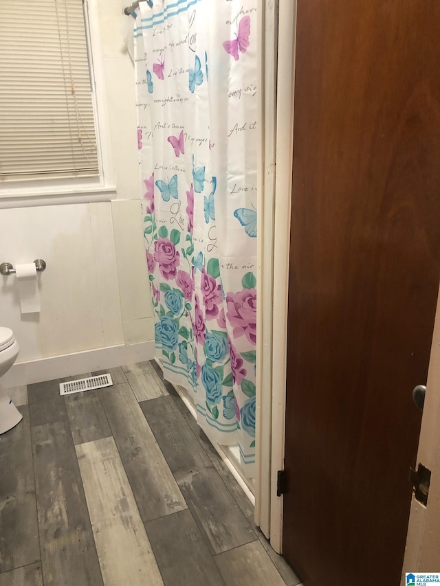 bathroom featuring toilet and hardwood / wood-style floors