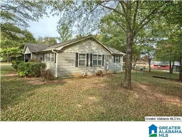 view of side of home featuring a lawn