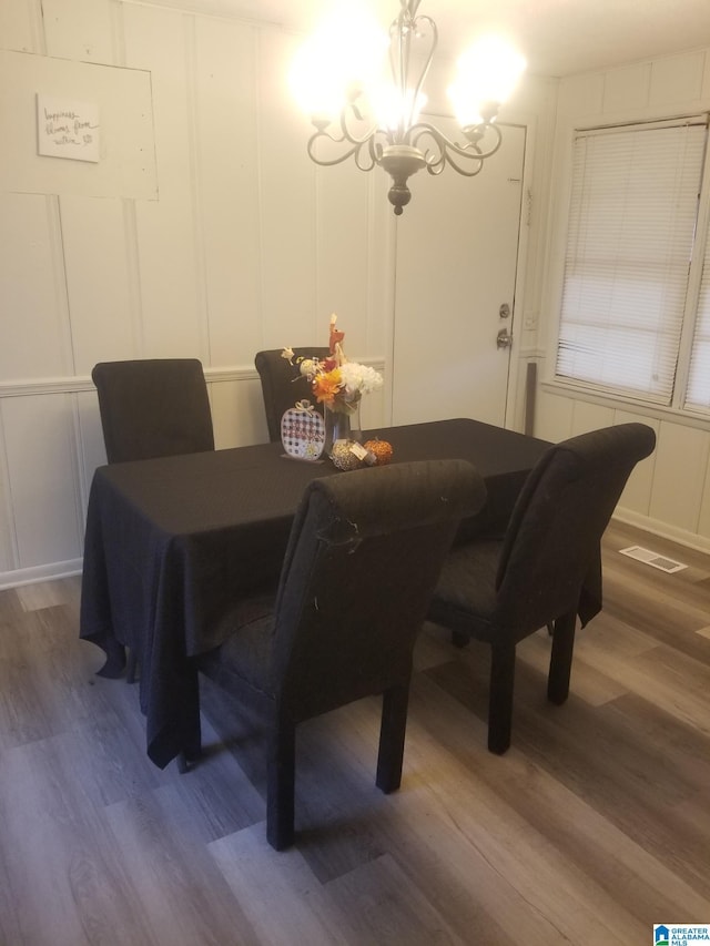 dining space with a chandelier and dark wood-type flooring