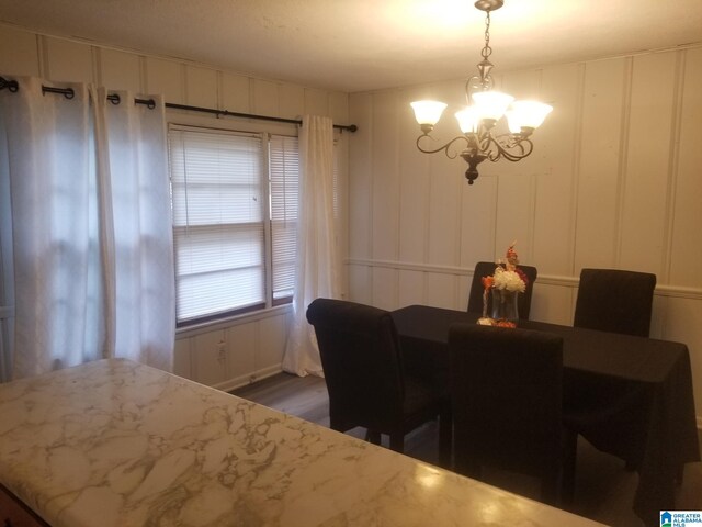 dining space featuring a notable chandelier and dark hardwood / wood-style floors