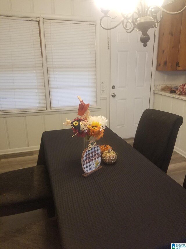 dining space featuring a notable chandelier and hardwood / wood-style flooring