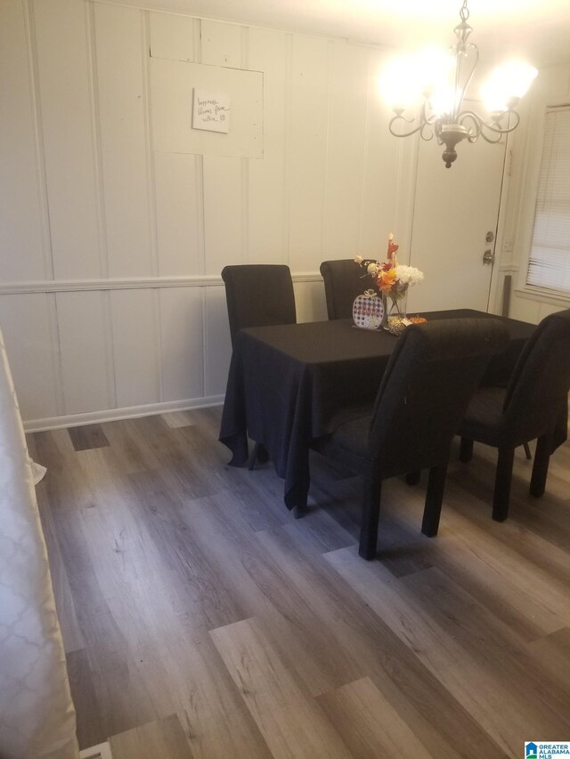 dining area with an inviting chandelier and dark hardwood / wood-style flooring