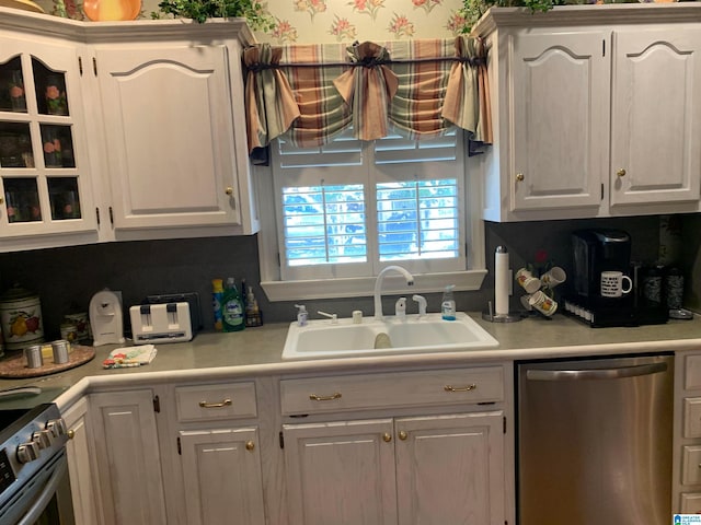 kitchen with white cabinetry, appliances with stainless steel finishes, and sink