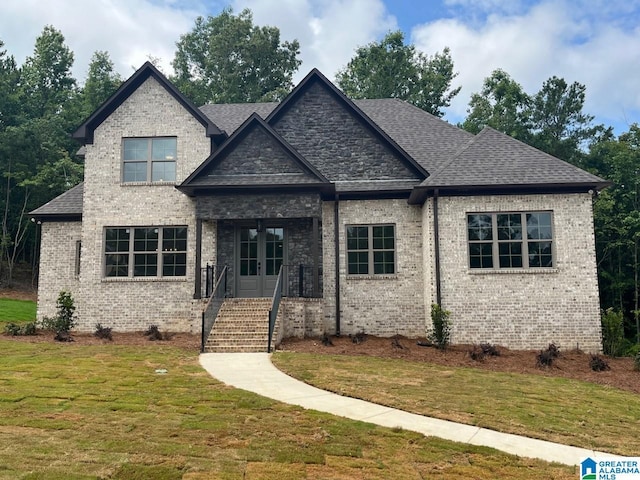 craftsman inspired home with a front lawn