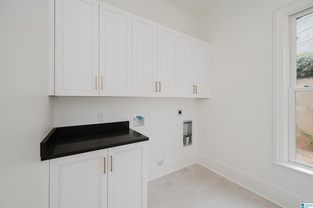 laundry room featuring hookup for a washing machine, plenty of natural light, cabinets, and hookup for an electric dryer