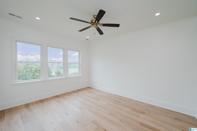 spare room featuring ornamental molding, ceiling fan, and light hardwood / wood-style floors