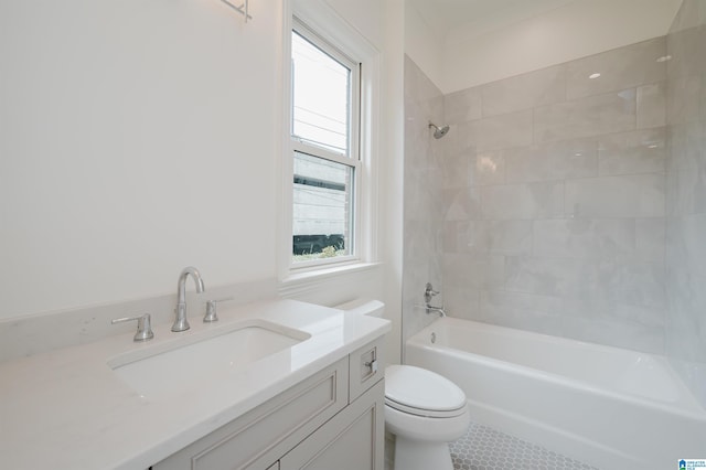 full bathroom featuring vanity, tiled shower / bath, and toilet