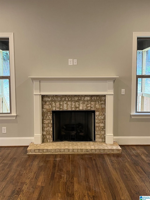 interior details with hardwood / wood-style flooring and a brick fireplace