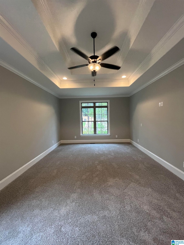 carpeted empty room with a raised ceiling, crown molding, and ceiling fan