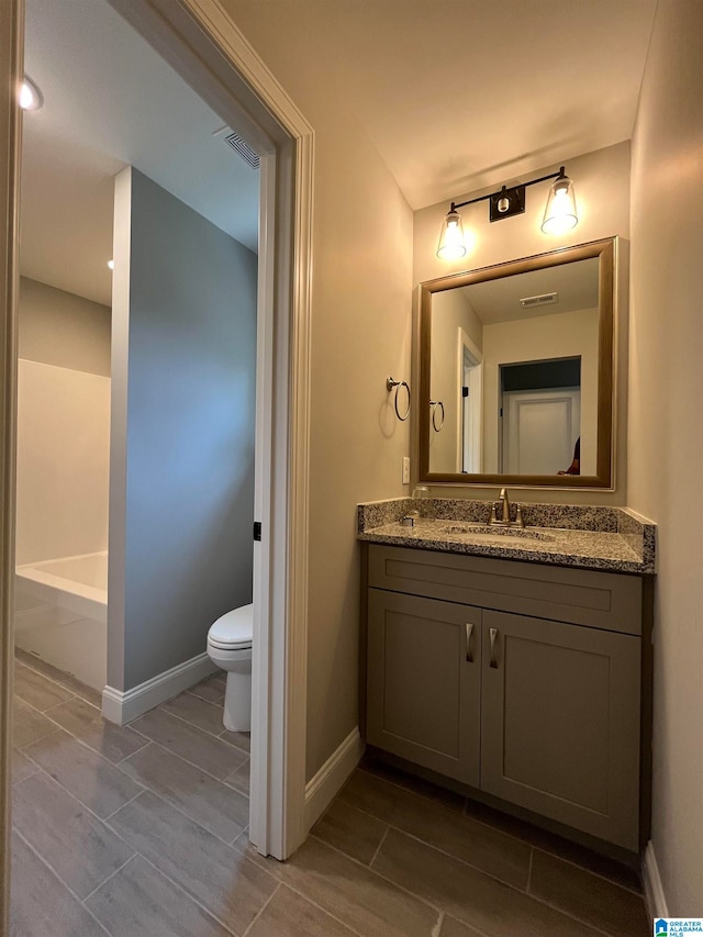 bathroom featuring vanity and toilet