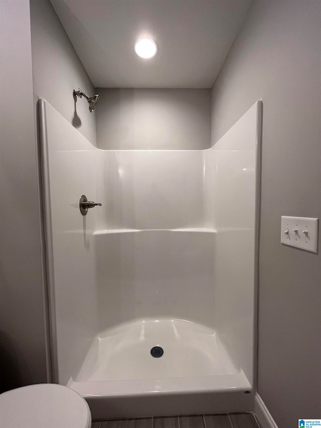 bathroom with toilet and walk in shower