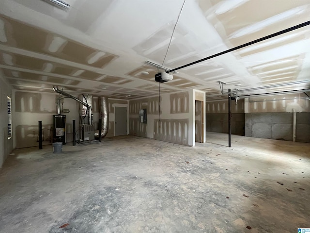 garage featuring electric panel, heating unit, a garage door opener, and water heater