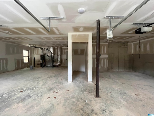 garage with heating unit, water heater, and a garage door opener