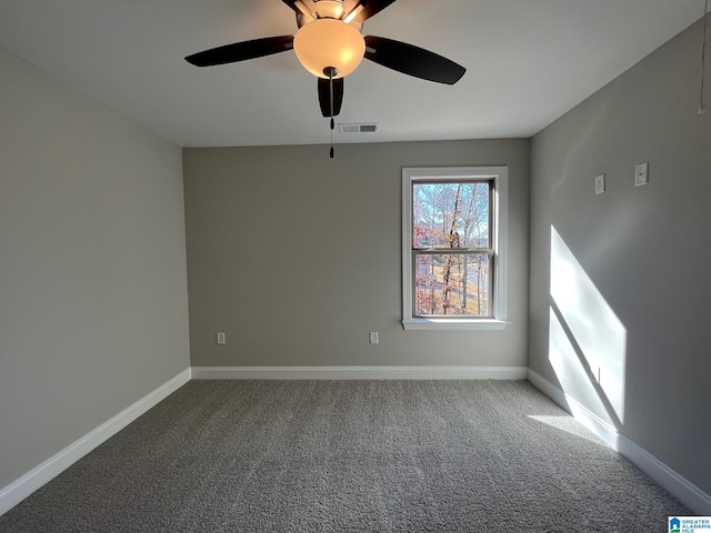 carpeted spare room featuring ceiling fan