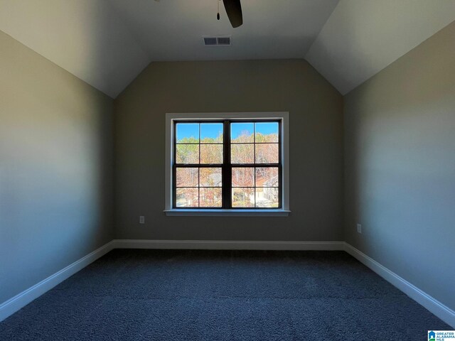 carpeted spare room with ceiling fan and lofted ceiling