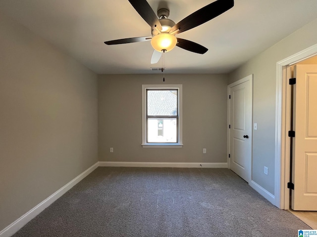 spare room featuring ceiling fan and light colored carpet