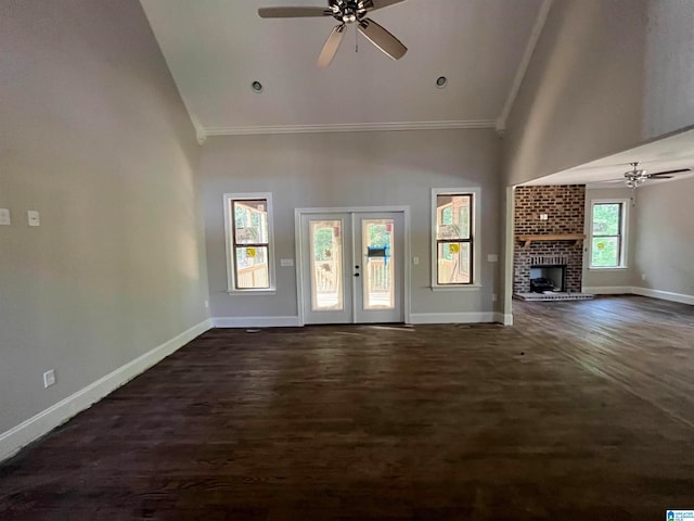 unfurnished living room featuring a wealth of natural light, a fireplace, high vaulted ceiling, and french doors