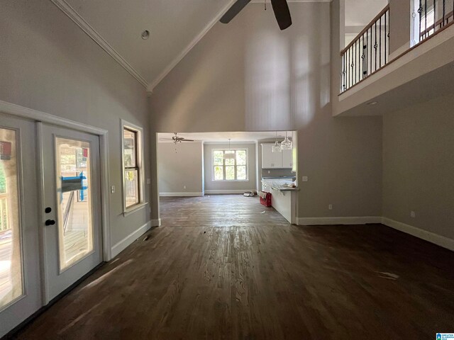 interior space with french doors, ornamental molding, ceiling fan with notable chandelier, high vaulted ceiling, and dark hardwood / wood-style floors