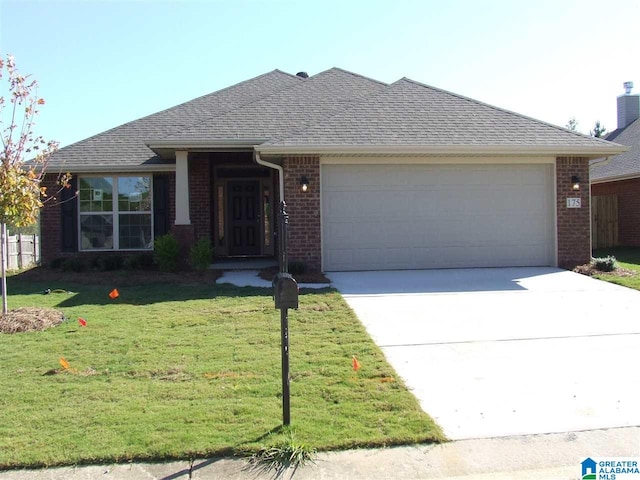 single story home with a front yard and a garage