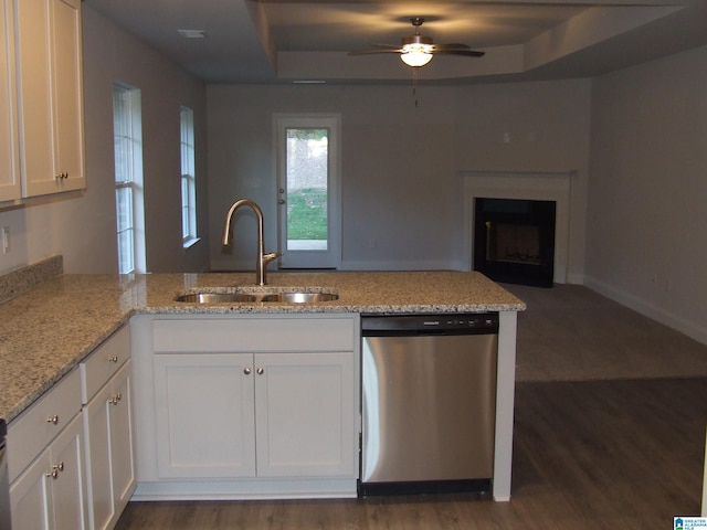 kitchen with stainless steel dishwasher, ceiling fan, white cabinets, sink, and dark hardwood / wood-style floors