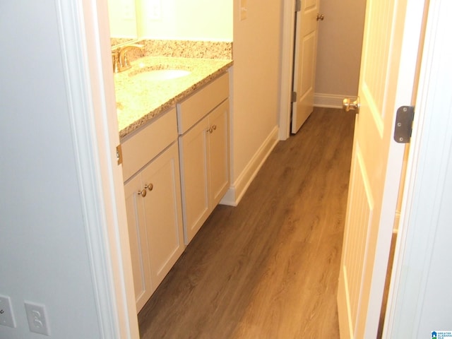 hall with wood-type flooring and sink