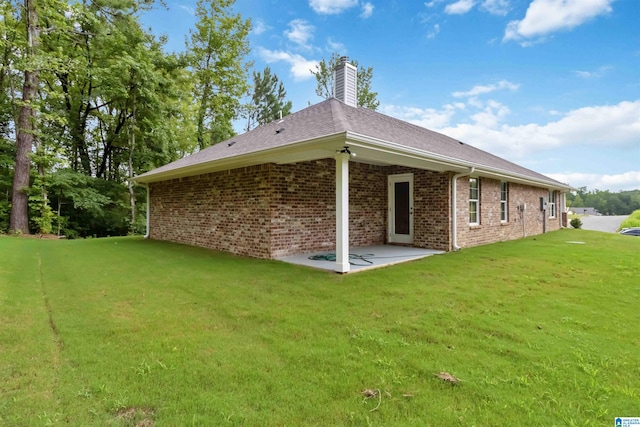 back of property featuring a yard and a patio area