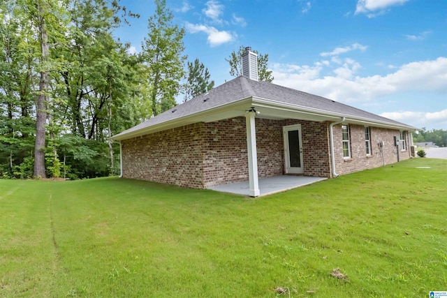 back of house featuring a patio and a yard