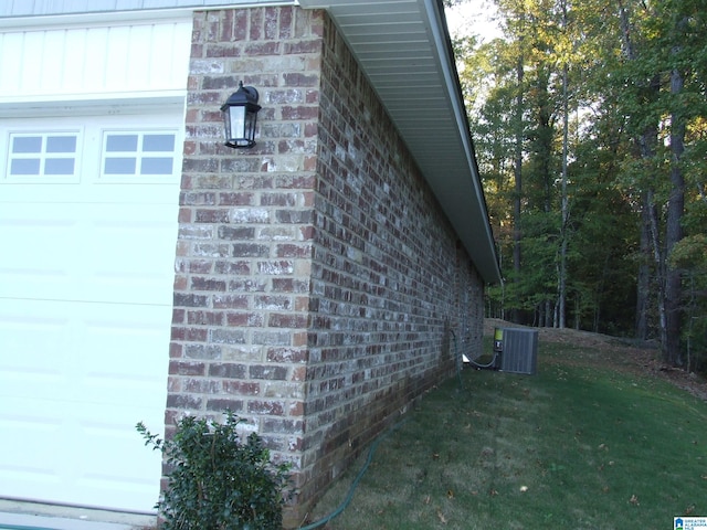 view of side of home with cooling unit and a lawn