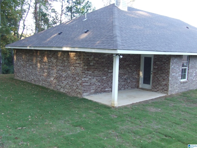 back of property with a patio and a yard