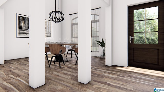 entrance foyer with hardwood / wood-style flooring and a chandelier