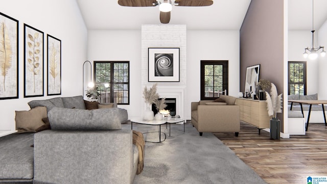 living room with ceiling fan with notable chandelier, a large fireplace, wood-type flooring, and high vaulted ceiling