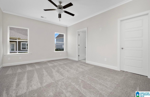 unfurnished room with carpet floors, ceiling fan, and ornamental molding