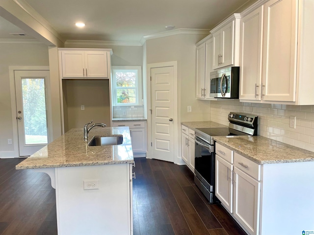 kitchen featuring stainless steel appliances, an island with sink, white cabinets, and sink