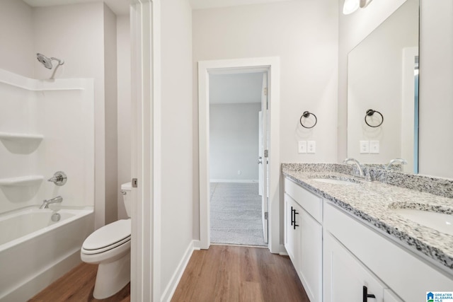 full bathroom featuring toilet, vanity, wood-type flooring, and shower / bathing tub combination