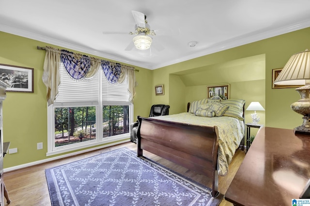 bedroom with ornamental molding, hardwood / wood-style floors, and ceiling fan