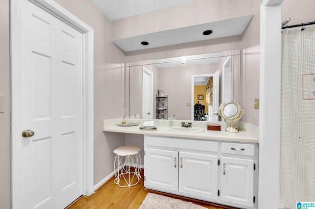 bathroom featuring hardwood / wood-style floors and large vanity